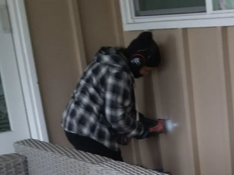Professional electrician installing an exterior outlet in Kitty Hawk