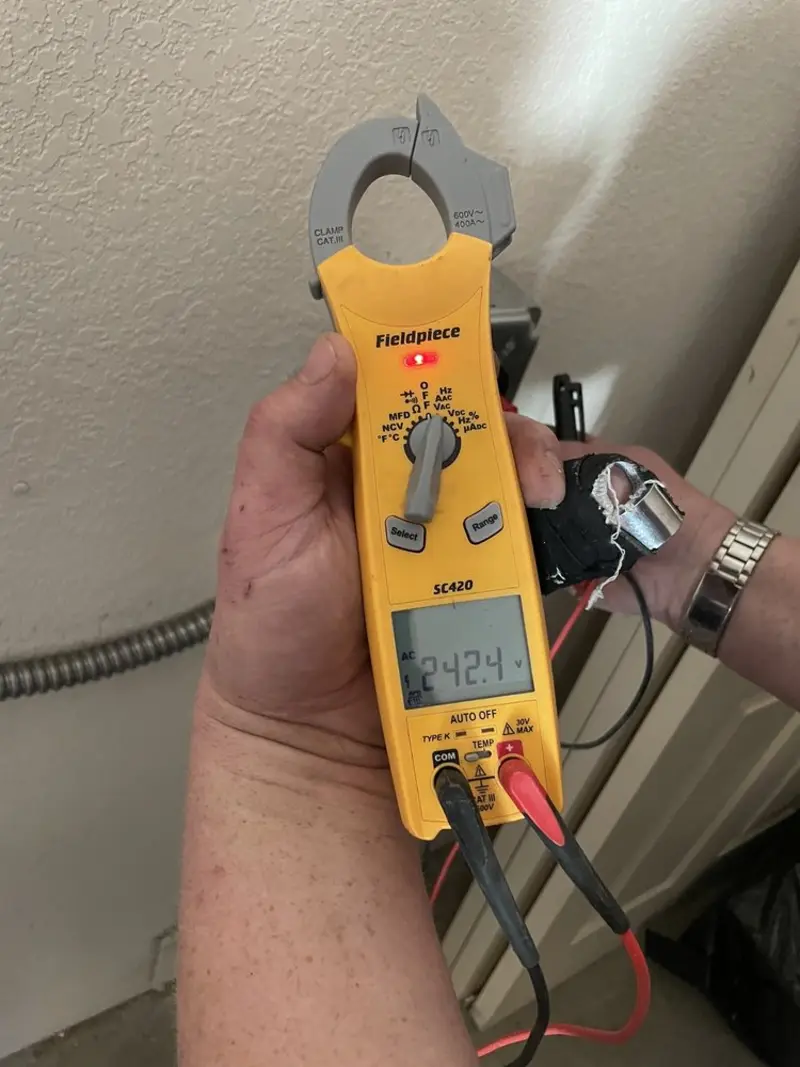 Voltage testing with clamp meter during Outlet Installation in Kitty Hawk